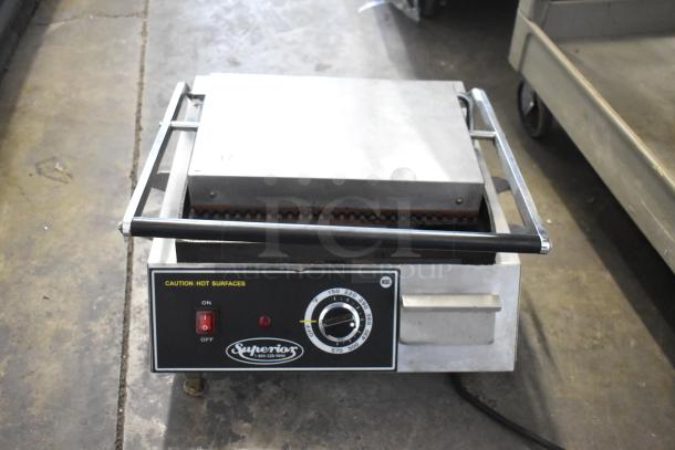 Superior SPGM1 stainless steel commercial countertop panini press, 120V, 1 phase. Features temperature dial and caution label.