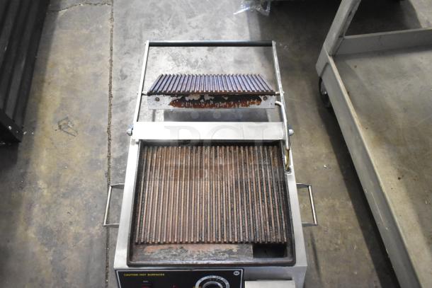 Superior SPGM1 stainless steel commercial countertop panini press, used condition, 120 volts, single phase, caution label visible.