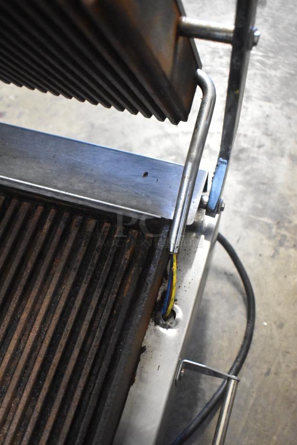 Superior SPGM1 stainless steel panini press, commercial countertop model. Ribbed plates, 120V, 1 phase, moderate wear visible.