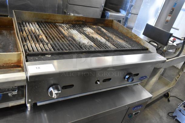 Cook Rite stainless steel countertop charbroiler, natural gas powered, visible wear on grates, brand logo on front.