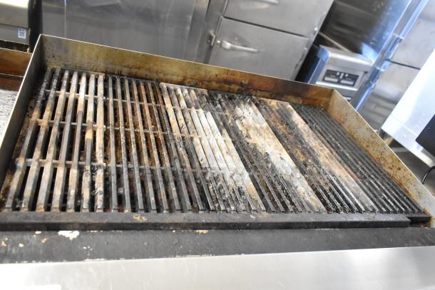 Cook Rite stainless steel commercial charbroiler, natural gas powered, showing signs of heavy use.
