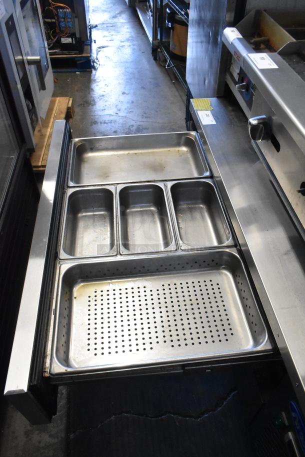 2018 Atosa MGF8451GR stainless steel 2-drawer chef base, on commercial casters, with removable stainless pans visible.
