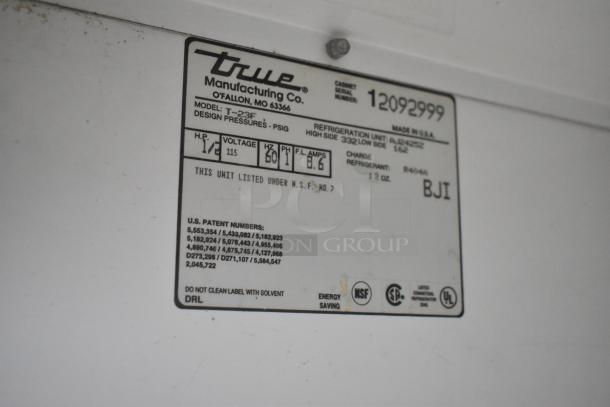 True T-23F freezer label showing model, voltage (115V), phase (1), and patent numbers. NSF and energy-saving symbols present.