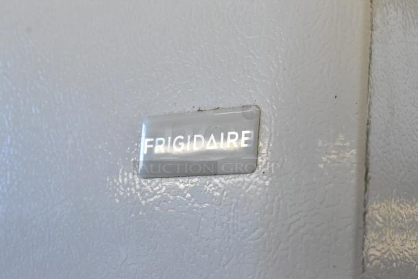 Frigidaire FFRU17B2QWE cooler, metal single door, 115 volts, 1 phase, Frigidaire logo on textured surface.