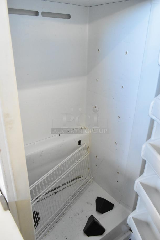 Frigidaire FFRU17B2QWE single door reach-in cooler interior, metal, 115 volts, 1 phase, clean condition with shelving.