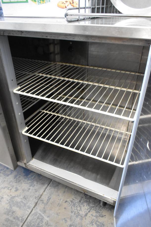 Duke RUF-48M stainless steel 2-door undercounter cooler, 120V, 1 phase, with three white wire shelves, clean interior.