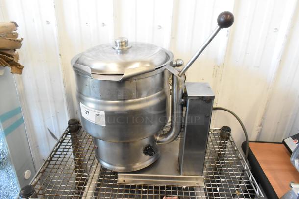 Groen stainless steel electric tilting steam kettle, commercial-grade, countertop design. Visible controls and lever, good condition.