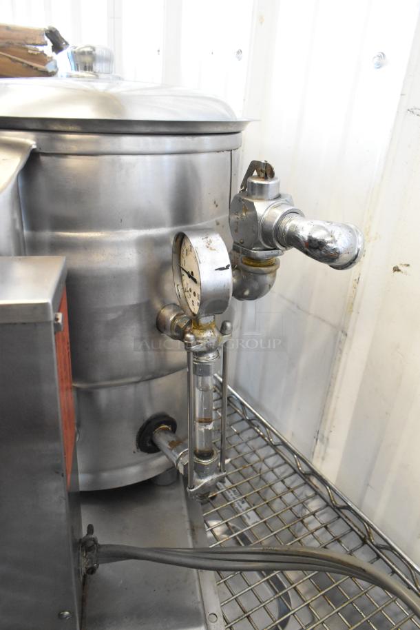 Groen stainless steel commercial electric tilting steam kettle, gauge and valve visible, in used condition.
