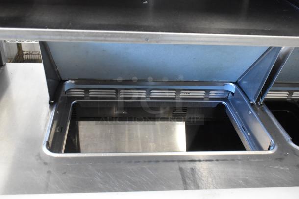 Delfield stainless steel sandwich salad prep table with 4 drawers and over shelf, 115V, 1 phase. Visible bain marie section.