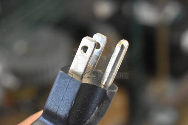 Plug detail of Paragon 6133310 Arctic Blast Snow Cone Machine, 115 volts, 1 phase, labeled as brand new with scratches and dents.