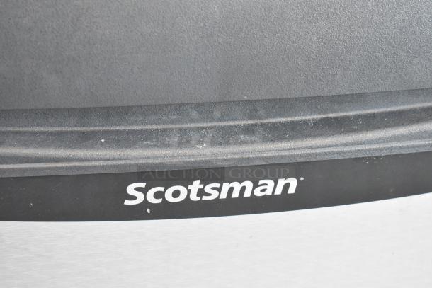 Brand new Scotsman UC2024MA-1A ice machine close-up, minor scratches visible, 227 lb capacity, 115V, 1 phase.