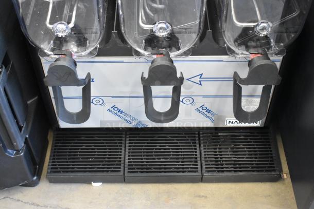 Brand new Narvon 378RBD5G3 stainless steel triple 5-gallon beverage dispenser with visible tap mechanisms and protective film.