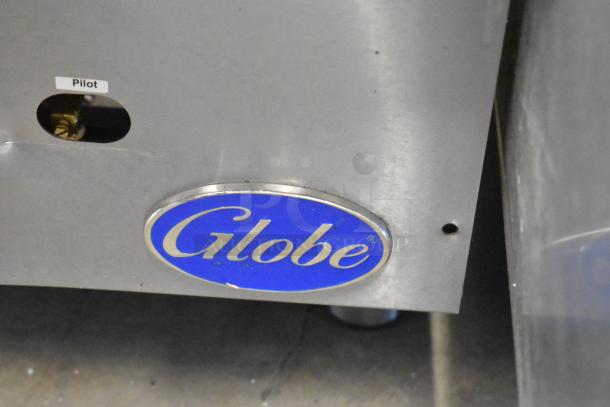 Globe stainless steel commercial gas flat top griddle with pilot indicator; features Globe logo, suitable for countertop use.