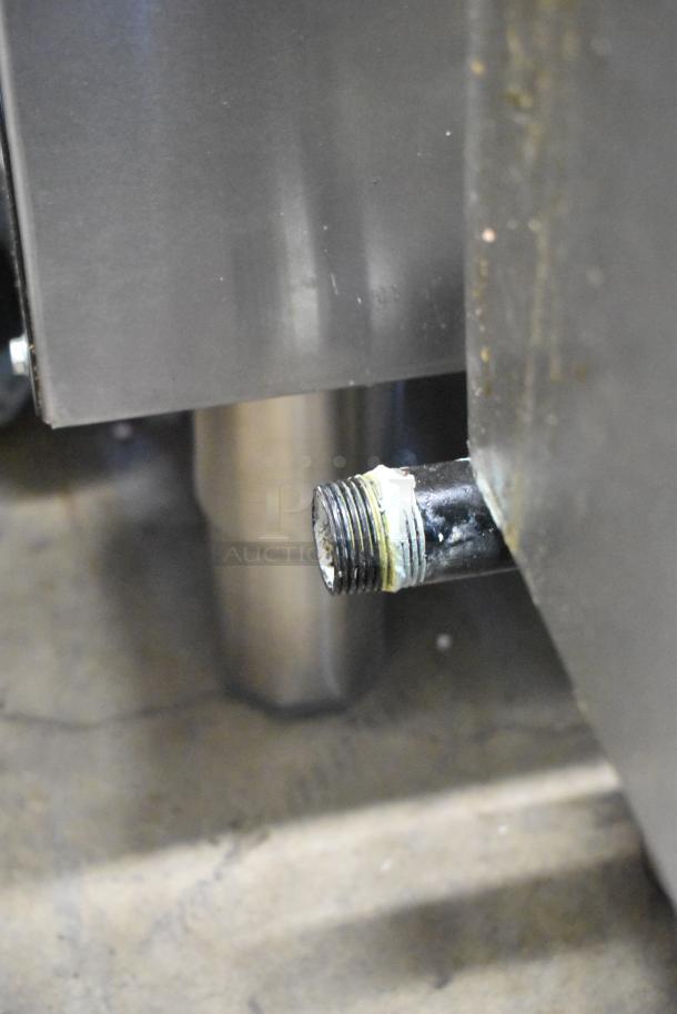 Globe stainless steel gas griddle with visible connection fitting. Commercial-grade, ideal for countertop use.