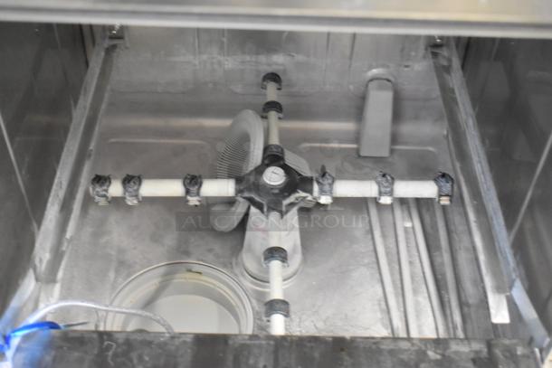 Stainless steel interior of Noble 495HTGW22 glass washer. Visible spray arm and components. New, scratch and dent condition.