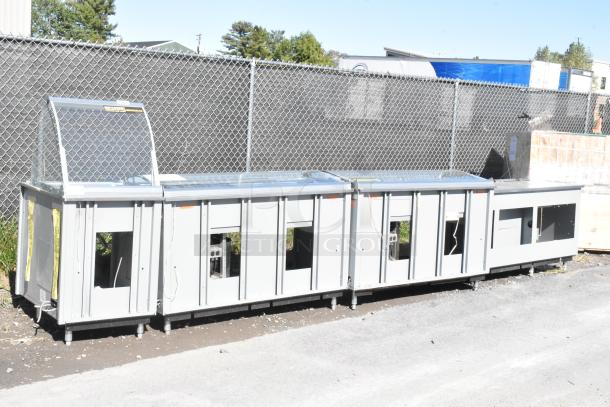 Duke stainless steel commercial sandwich prep line with lowering sneeze guard, 120 volts, 1 phase, outdoor setting.
