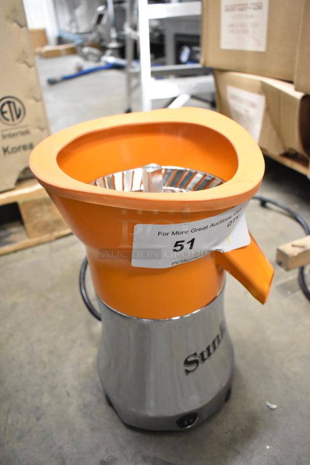 BRAND NEW SCRATCH AND DENT! Sunkist PJF-A12959 Black Pro Series Citrus Juicer, 115V, with orange funnel and label marked "51".