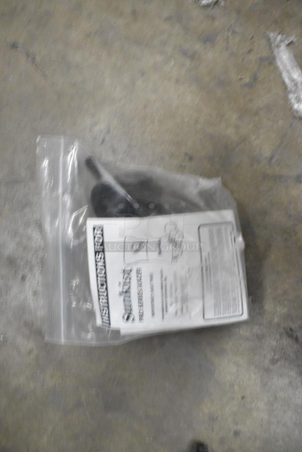Sunkist PJF-A12959 Pro Series Citrus Juicer, black, 115V, scratch and dent, in plastic bag with instructions visible.