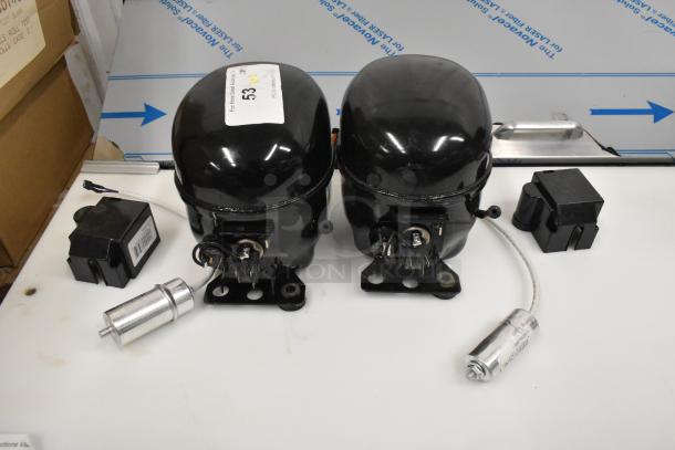 Two Cubigel NUT55NR and NUT70NR compressors, brand new, scratch and dent, 115-127 volts, 1 phase, with accessories.
