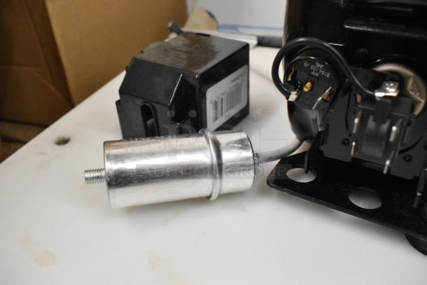 Cubigel NUT55NR and NUT70NR compressors, scratch and dent, 115-127V, 1 phase, components visible, new condition.