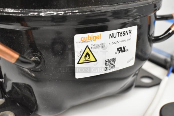Cubigel NUT55NR compressor, scratch and dent, 115-127V, thermally protected, R290 refrigerant label visible.