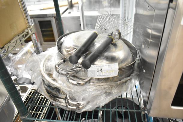 Nine brand new scratch and dent metal pots with lids and whisks, wrapped in plastic, auction label visible.