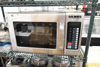 Brand new Solwave stainless steel commercial microwave oven, scratch and dent, with digital keypad and label showing model details.