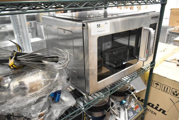 BRAND NEW Solwave Stainless Steel Commercial Microwave Oven with minor dents, visible piece on shelf, robust handle, labeled for auction.