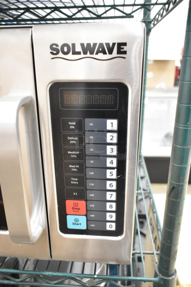 Brand new Solwave stainless steel commercial microwave oven with control panel showing cooking settings. Scratch and dent condition.