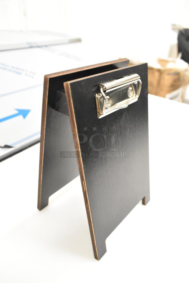 Standing clipboard with wood finish, metal clip, and slight wear. Set of 9, new with minor scratches and dents. Value pack.