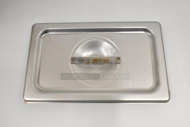 Brand new Vigor 24714SLD 1/4 Size Solid Stainless Steel Steam Table Pan Cover with visible branding and model markings.