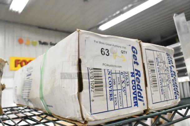 2 new scratch and dent boxes of Inteplast Group BP21635 plastic bun pan covers, 21"x6"x35", 200/Case, visible packaging.