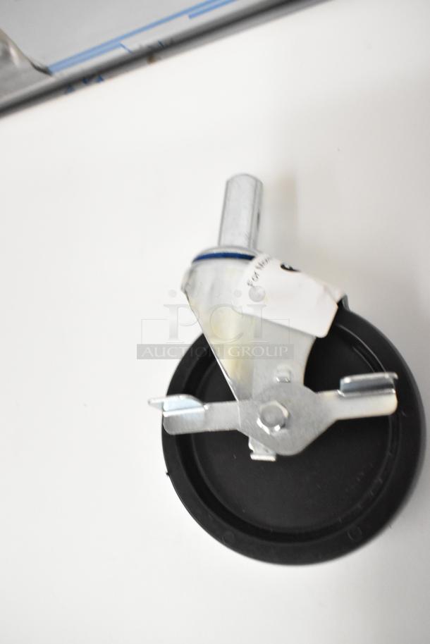 Lot of 4 brand new commercial casters, scratch and dent. Metal frame, black wheel, labeled with usage details.