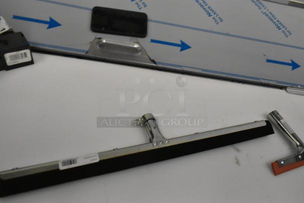 7 brand new squeegee heads with tags, models 36632400 and 27140072, minor scratches and dents visible.