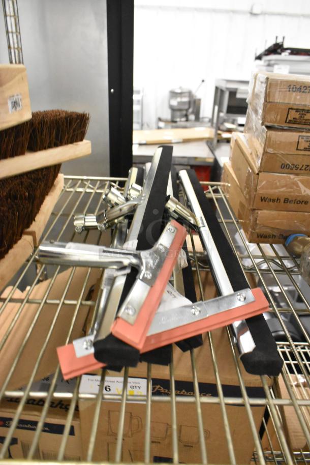 Seven brand new scratch and dent squeegee heads, models 36632400 and 27140072, on wire shelf.