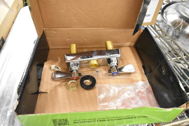 Brand new Regency faucet handles with minor cosmetic scratches and dents. Includes two handles, mounting hardware, and washers.