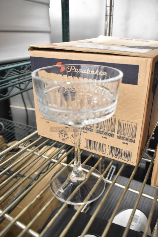 Pasabahce Elysia glass on shelf, standing next to its original packaging. Box labeled with Pasabahce branding. New condition.