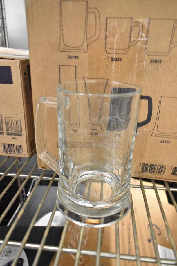 Brand new scratch and dent Pasabahce 22 oz. beer mug from Steelite International, shown on shelf with box.