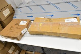 2 sealed boxes containing a 14" aluminum wide rim pizza pan and silver table stands numbered 1-10; minor outer wear.