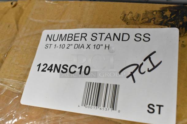 Box label shows "Number Stand SS ST 1-10 2" DIA X 10" H," model 124NSC10, with barcode and handwritten note.