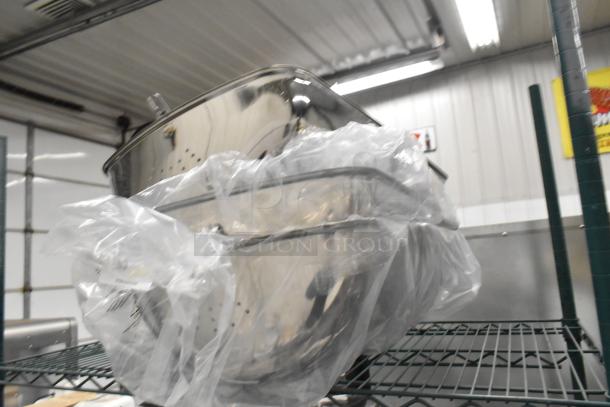 Three brand new Acopa 8 Qt. 922EC15CHRLD roll top chafers with chrome trim, partially covered in protective plastic.