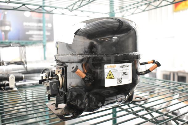 BRAND NEW Cubigel NUT70NR Compressor, 115-127V, 1 Phase. Minor scratches. Thermally protected, with safety and certification labels.