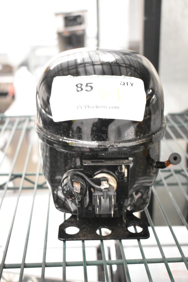 Brand new Cubigel NUT70NR compressor, 115-127V, 1 phase, with minor scratches. Label indicates auction site and item number.
