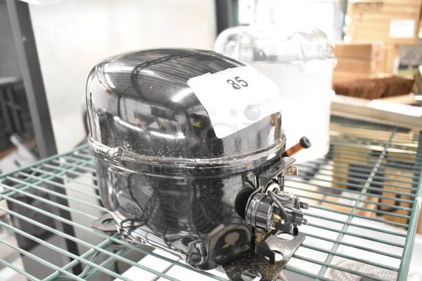 BRAND NEW SCRATCH AND DENT Cubigel NUT70NR Compressor, 115-127 Volts, 1 Phase, with label indicating item number 85.