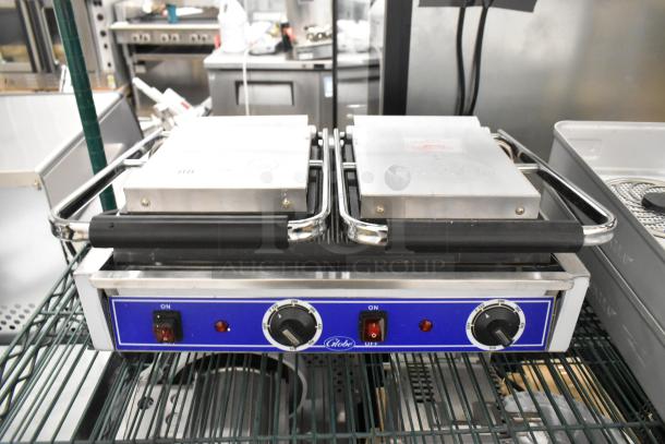 Brand new Globe stainless steel commercial countertop double panini press with scratch and dent condition. Adjustable knobs.