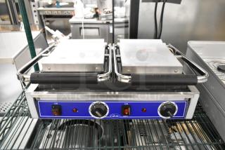 Brand new Globe stainless steel commercial countertop double panini press with scratch and dent condition. Adjustable knobs.