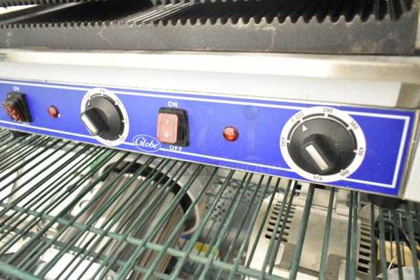 Globe stainless steel double panini press, scratch and dent condition, featuring control knobs and temperature settings.