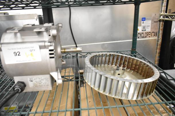 Brand new Nidec motor, 208-240 volts, 1 phase, visible scratches, includes label with auction details, located on metal shelving.