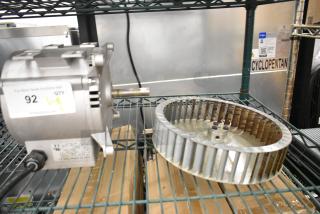 Brand new Nidec motor, 208-240 volts, 1 phase, visible scratches, includes label with auction details, located on metal shelving.