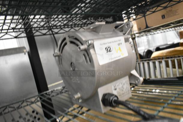 Brand new Nidec motor, 208-240V, 1 phase, slight scratches, visible label with auction info, on metal shelf.
